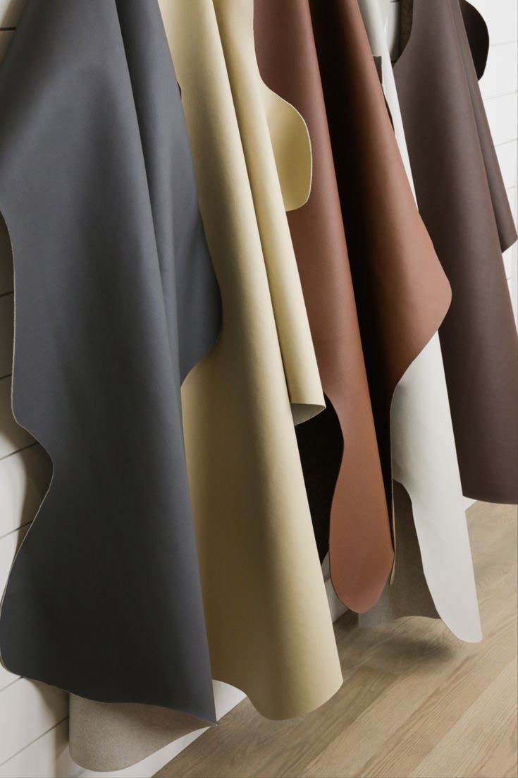 Leather hides stacked on industrial racks in a processing facility